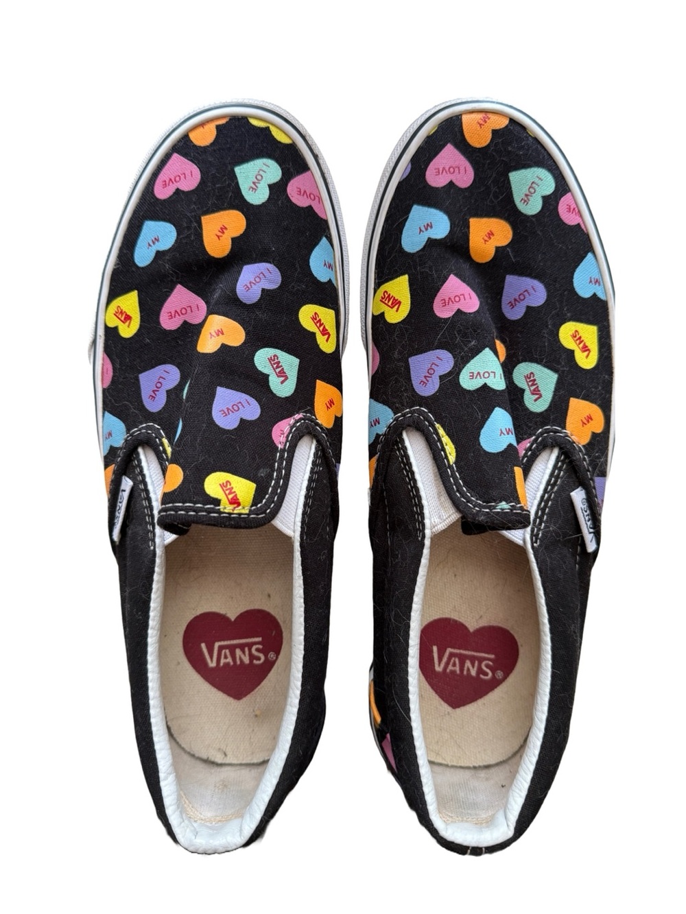 Vans Slip-On Sneakers in Black with Multicolor Heart Print